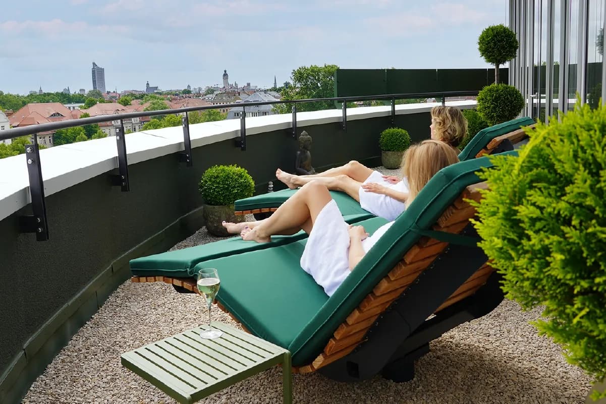 Zwei Frauen entspannen auf der Dachterrasse des Day Spa von RELAX plus mit Blick über Leipzig
